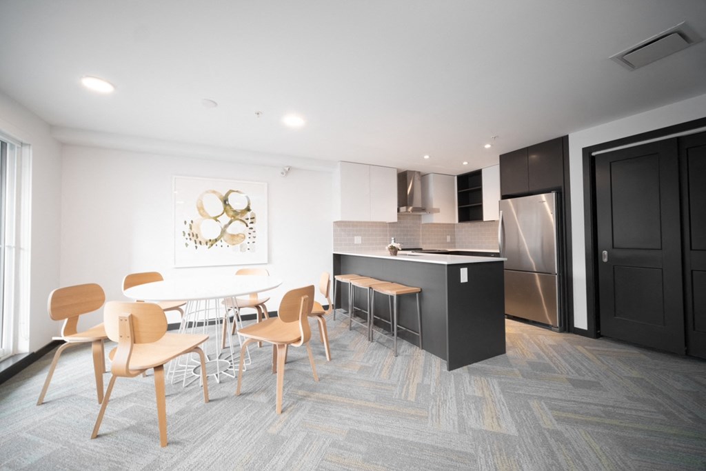 a dining room and kitchen with a table and chairs