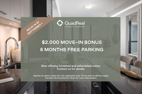 A modern kitchen interior is showcased with a promotional offer for QuadReal Real Estate Properties.