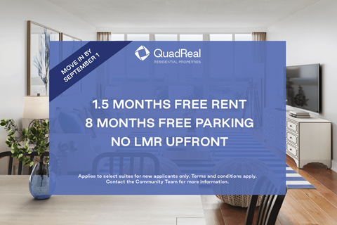 A blue advertisement board for QuadReal REALTORS advertising free rent and parking.