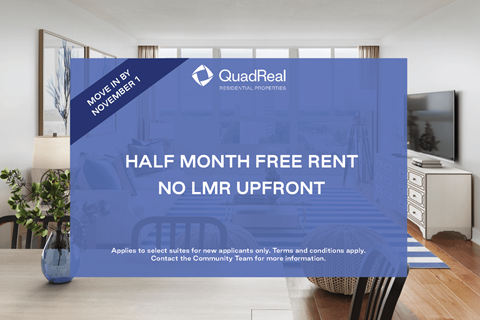 A room with a poster advertising a half month free rent offer from QuadReal.