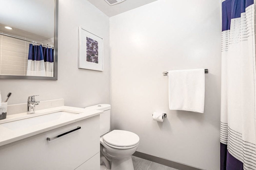 a bathroom with a sink toilet and a mirror