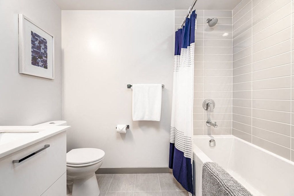 a bathroom with a toilet and a tub and a sink