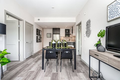 a dining room with a table and a tv
