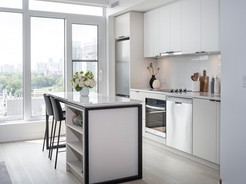A modern kitchen with white cabinets and a large island.