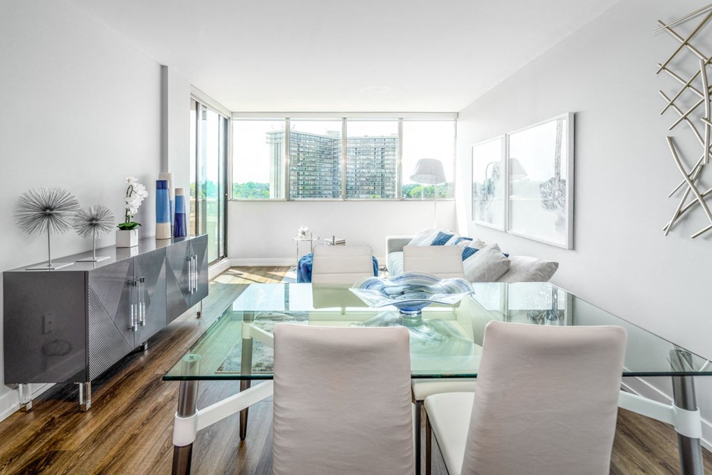 Open concept living and dining room staged with furniture.