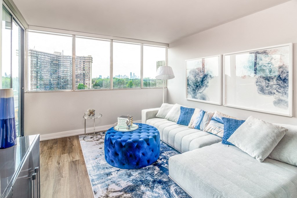 Sunny living room staged with furniture and a patio door opens to the balcony.