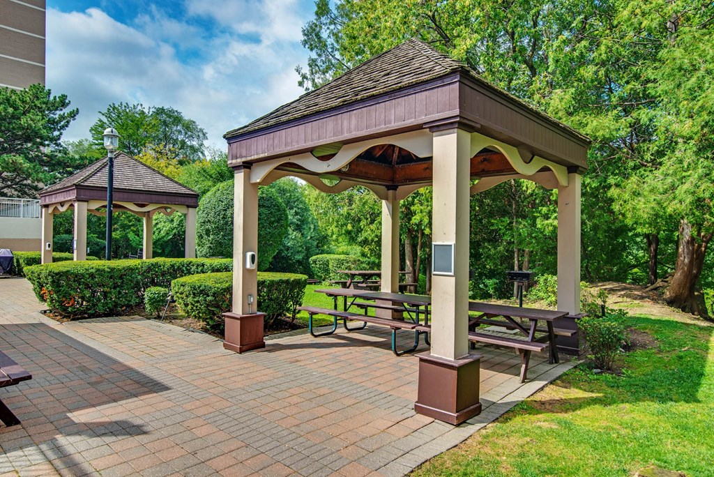 a pavilion with benches in a park
