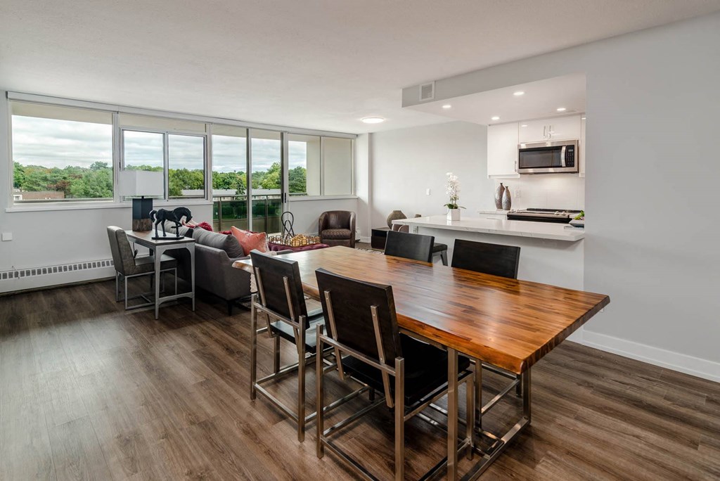 a dining room and living room with a table and chairs