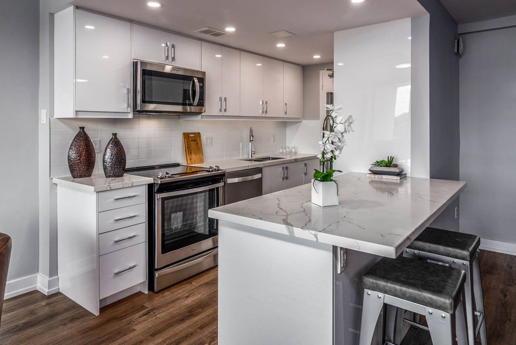 a kitchen with white cabinets and a counter top