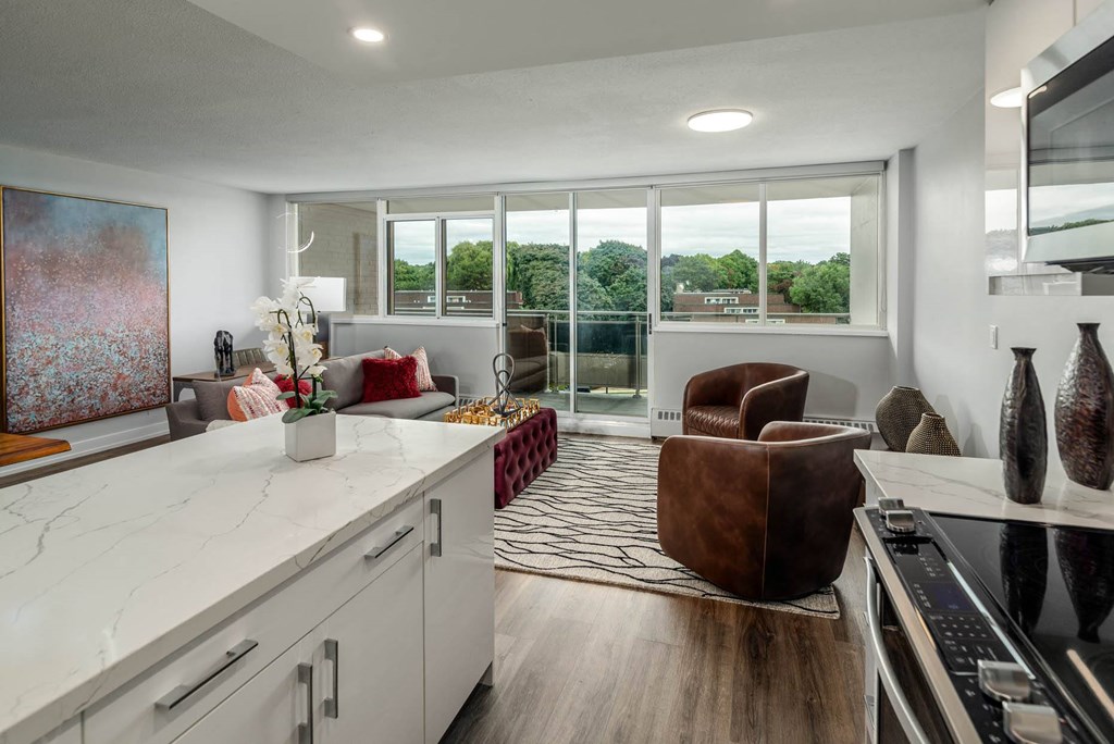 a living room with a couch and a kitchen
