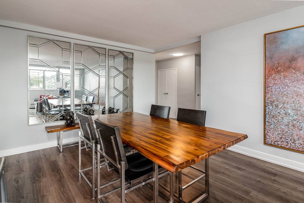 a dining room with a wooden table and chairs