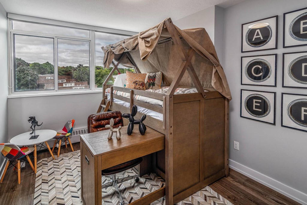 a bedroom with a bunk bed and a desk