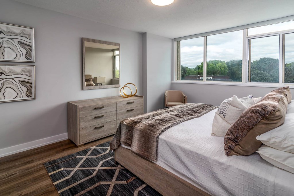 a bedroom with a bed and three windows