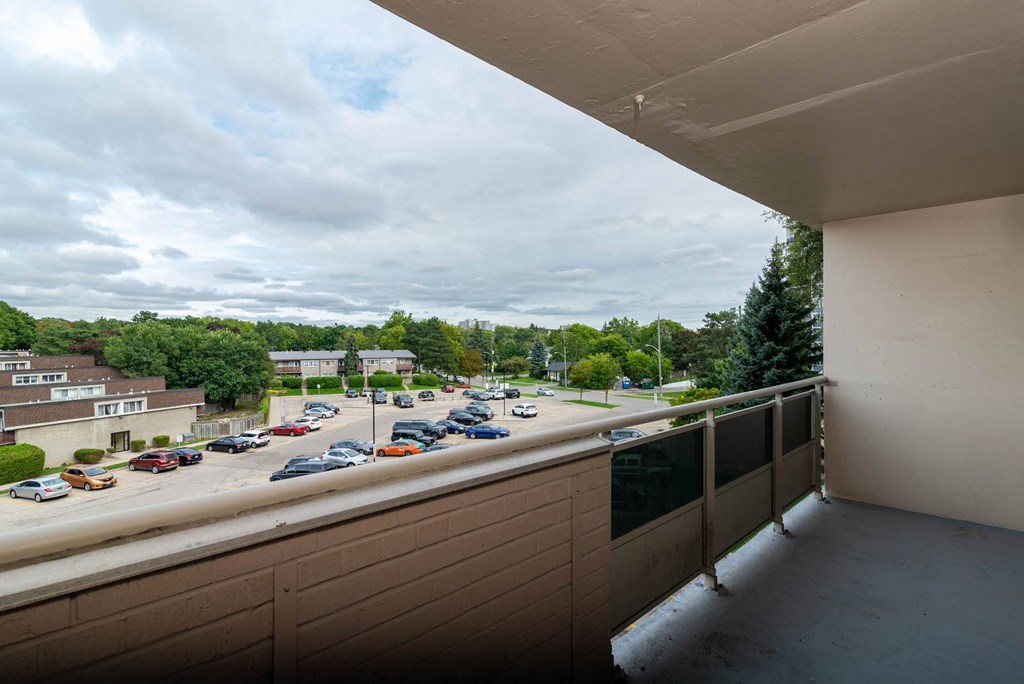 a balcony with a view of a parking lot