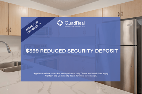 A kitchen with a QuadReal logo and a promotion for a reduced security deposit.