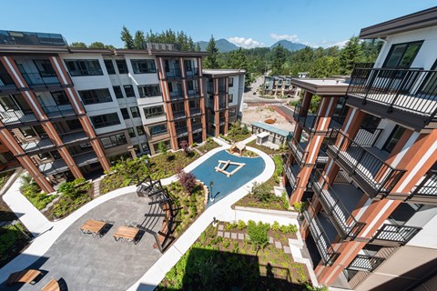 A view of a courtyard with a pool and apartment buildings.
