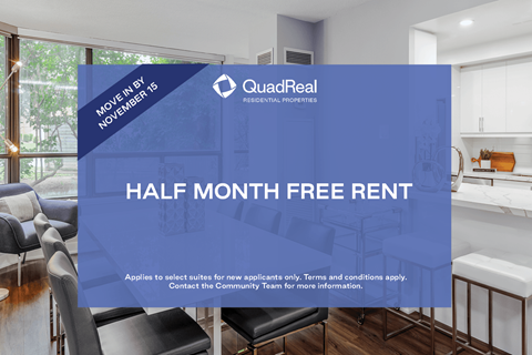 A room with a sign that says "Half Month Free Rent" in front of a kitchen area.