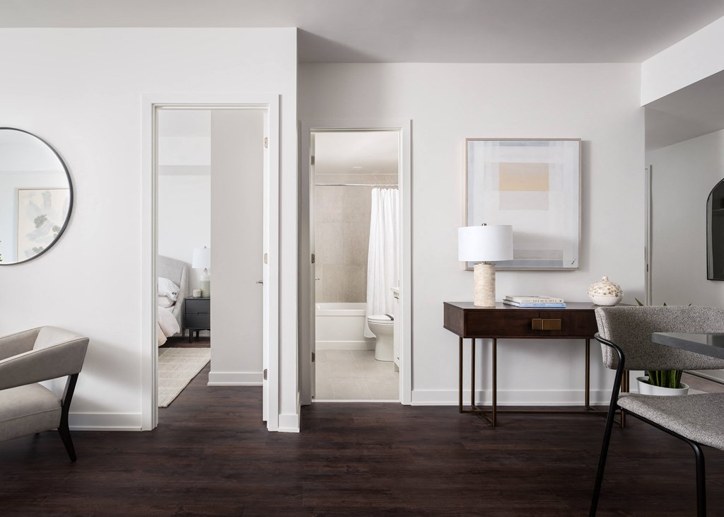 a view of a living room with a couch and a table with a lamp and