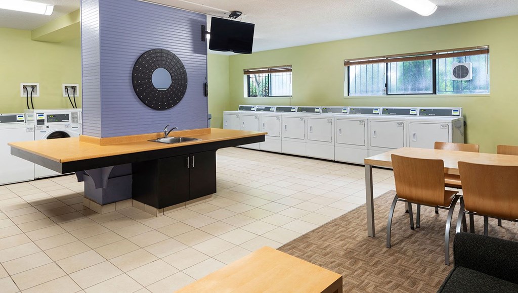 The laundry room, sparkling clean with walls of machines for your use.