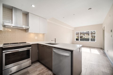 a kitchen with stainless steel appliances and a large counter top