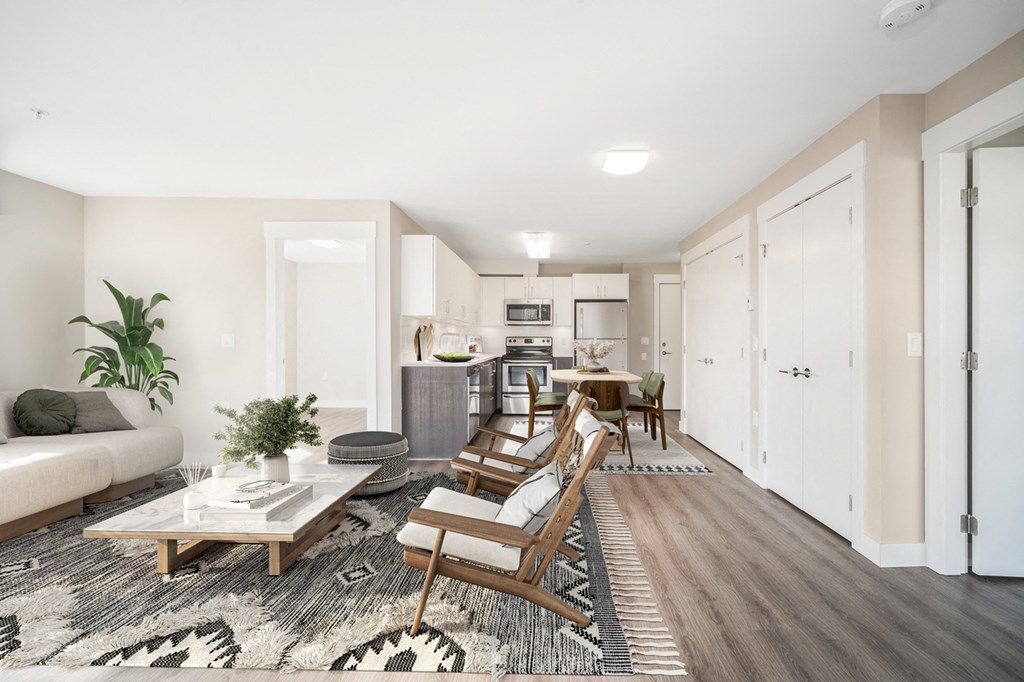 Beautifully staged two-bedroom apartment, looking from the living room straight through to the kitchen.