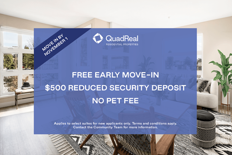 A room with a large advertisement for QuadReal REIT on the wall.