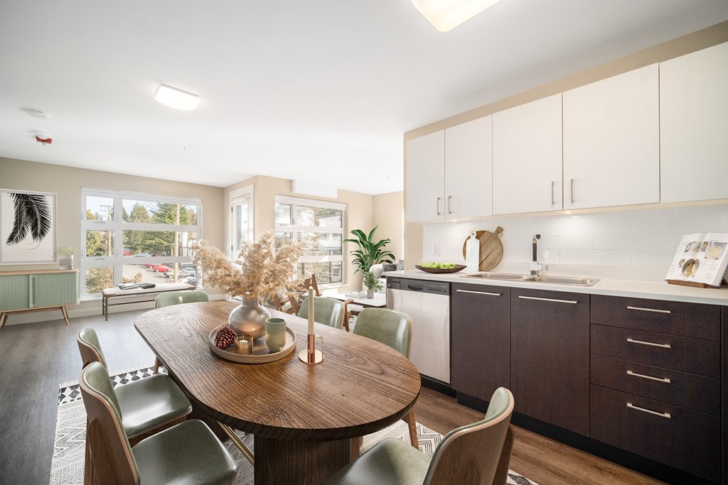 Staged kitchen looking through to spacious living room.