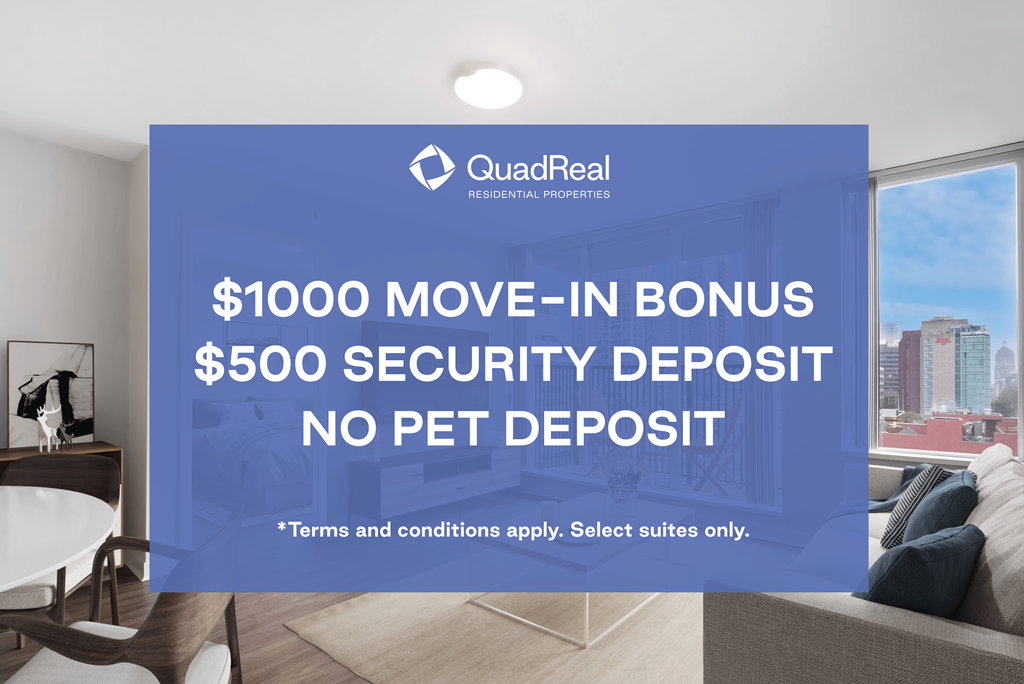 A room with a large window showing a cityscape and a sign advertising a $1000 move-in bonus and $500 security deposit from QuadReal Residential Properties.