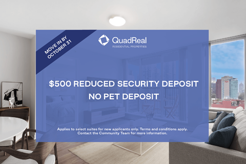 A sign advertising a $500 reduced security deposit for QuadReal Real Estate Services.