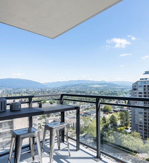 a view of the city from the balcony of a condo