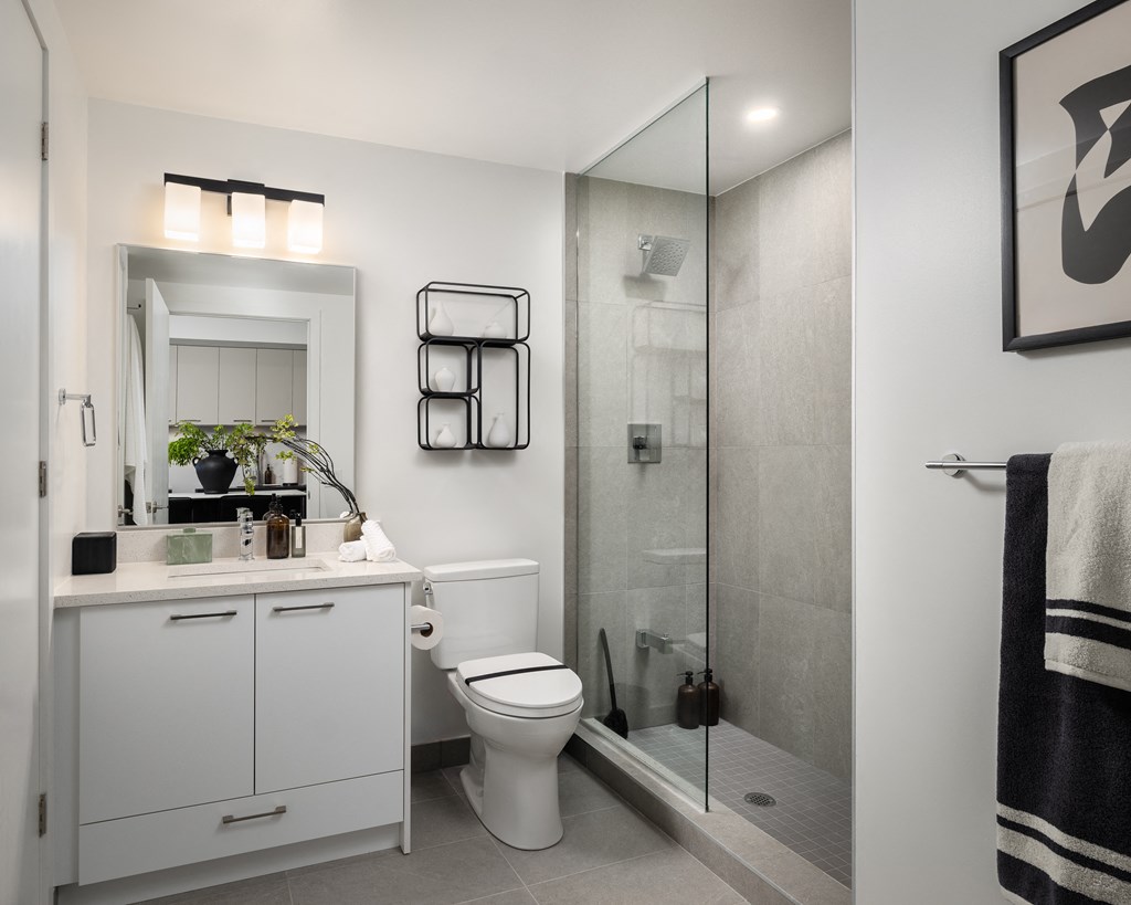 a small bathroom with a shower toilet and sink