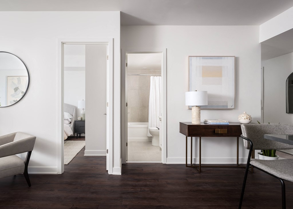 a view of a living room with a couch and a table with a lamp and