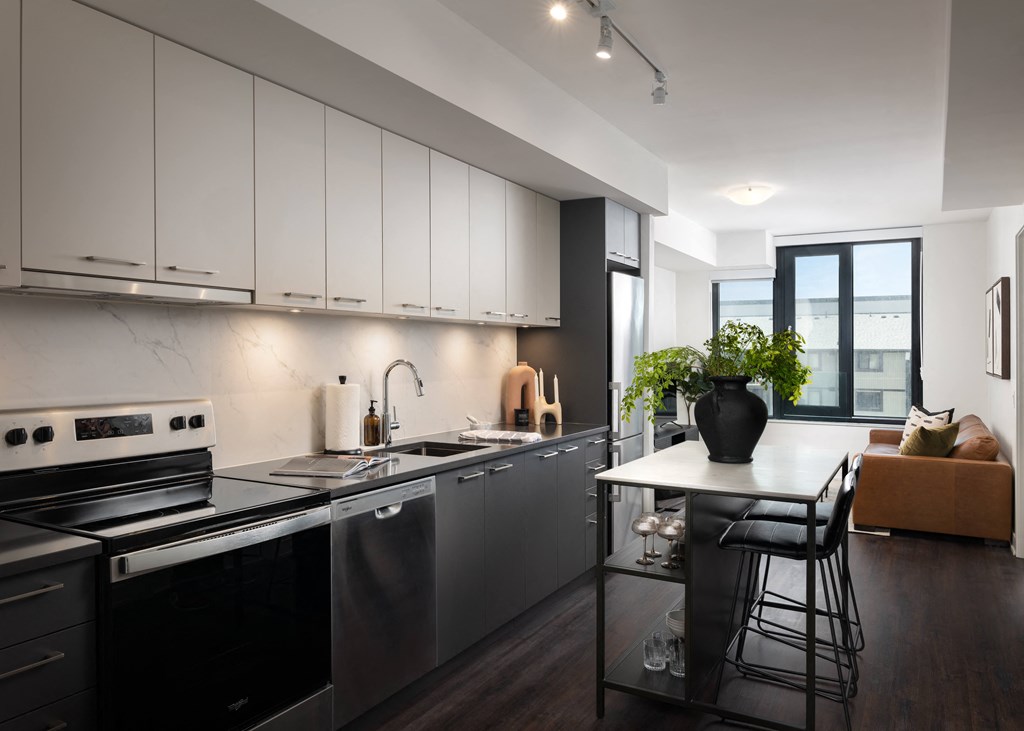 a kitchen with black appliances and a white counter top