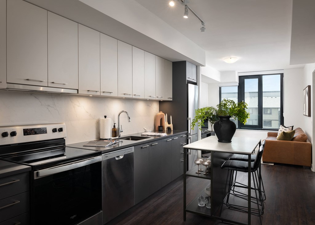 a kitchen with black appliances and a white counter top