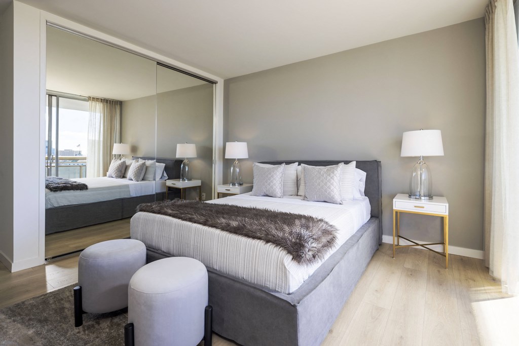 a bedroom with a bed and a mirror