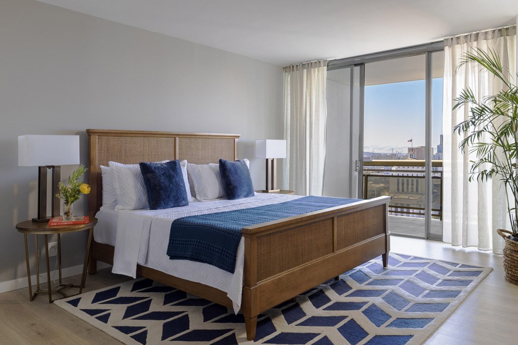 a bedroom with a bed and a view of the city