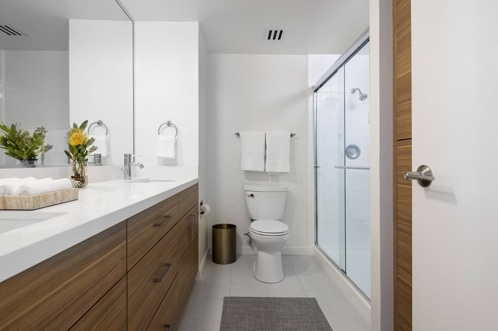 a bathroom with a toilet and a sink and a shower