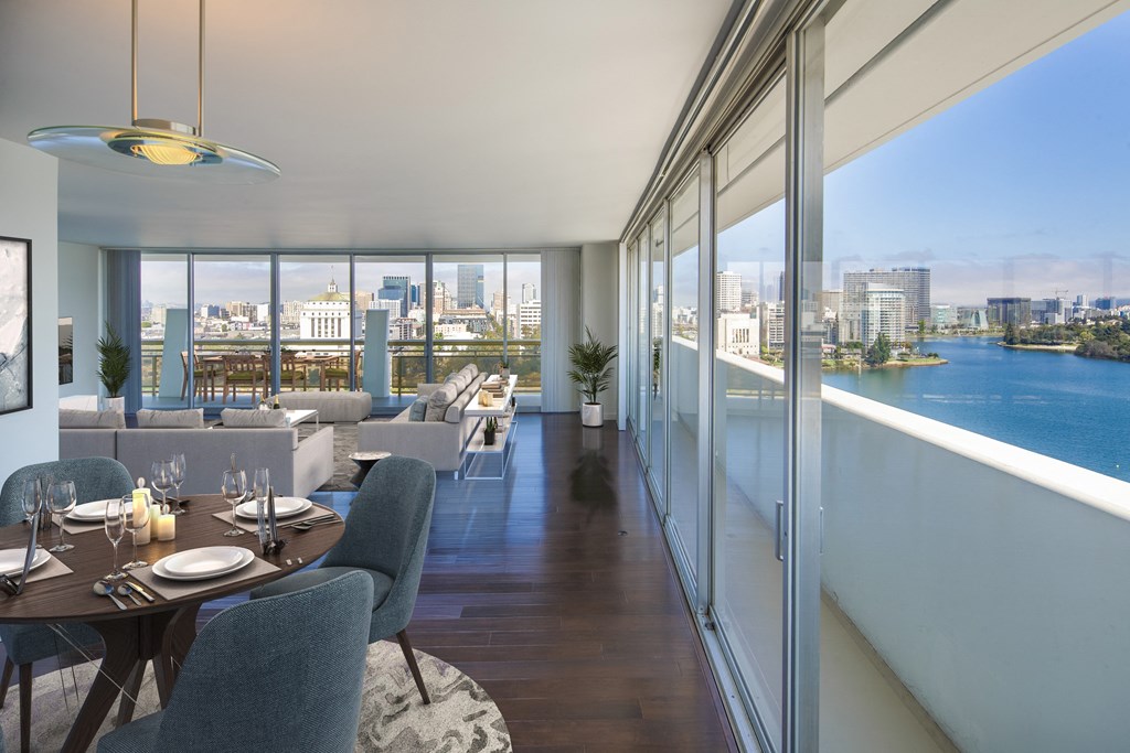 a rendering of a living room with tables and chairs and a balcony with a view