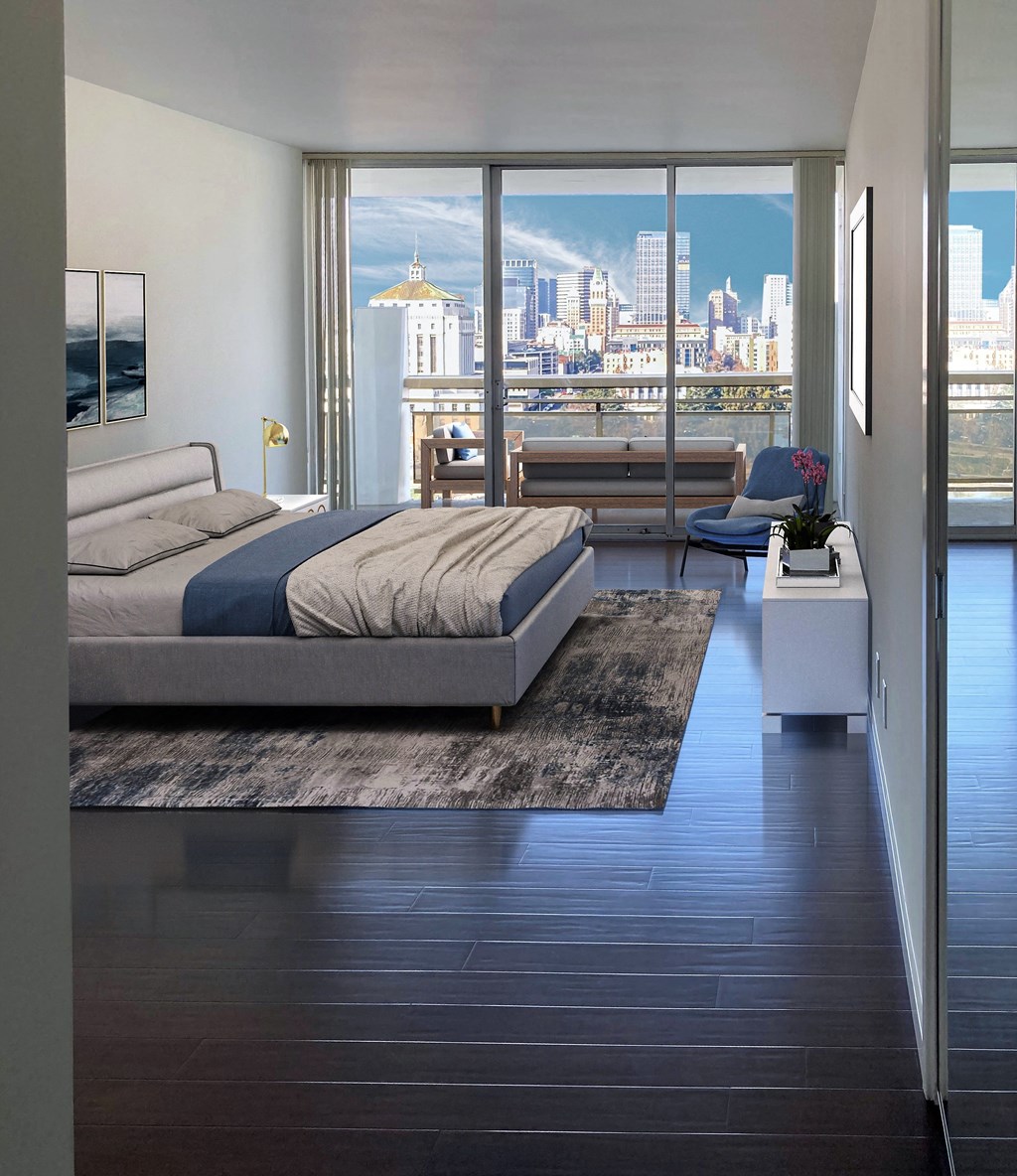 a bedroom with a bed and a view of the city