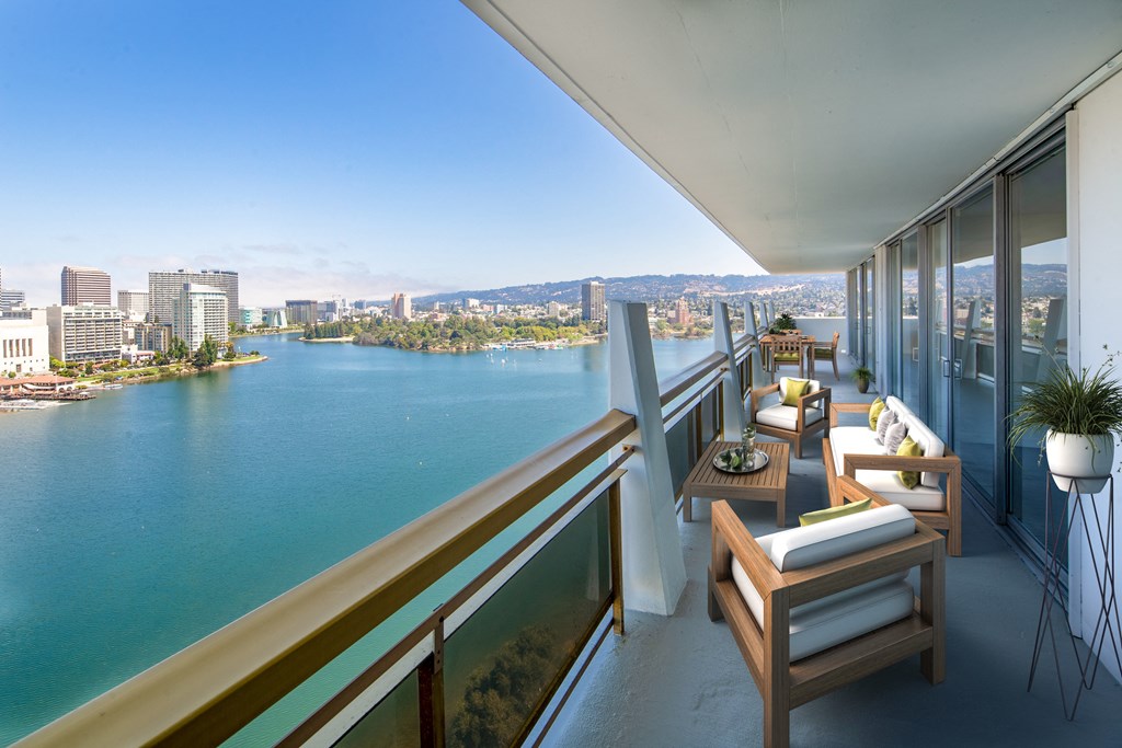 a balcony with a view of a river and a city