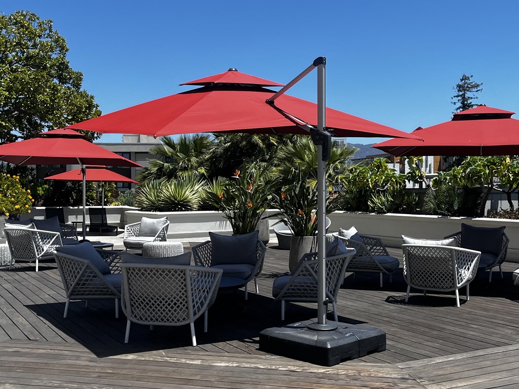 a patio with tables and chairs and umbrellas
