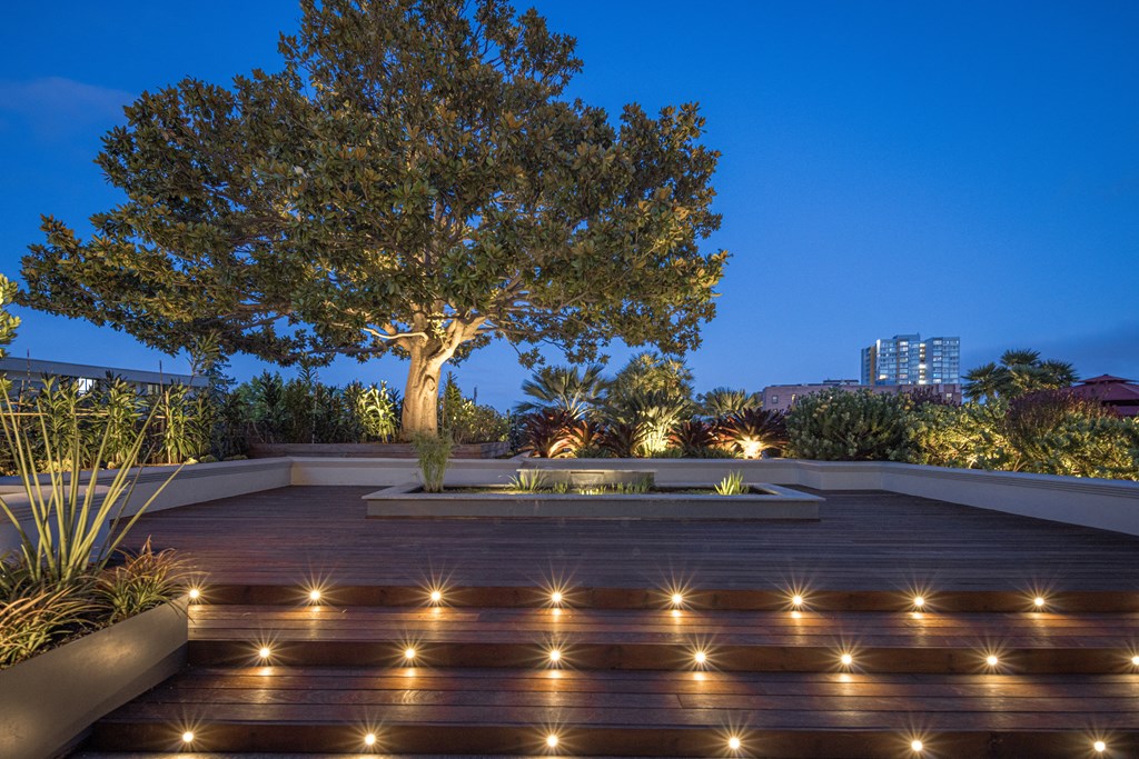 the terrace has a tree and lights on it