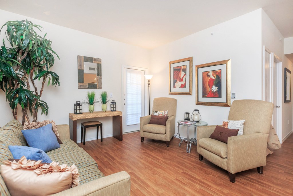 a living room with a couch and chairs and a table