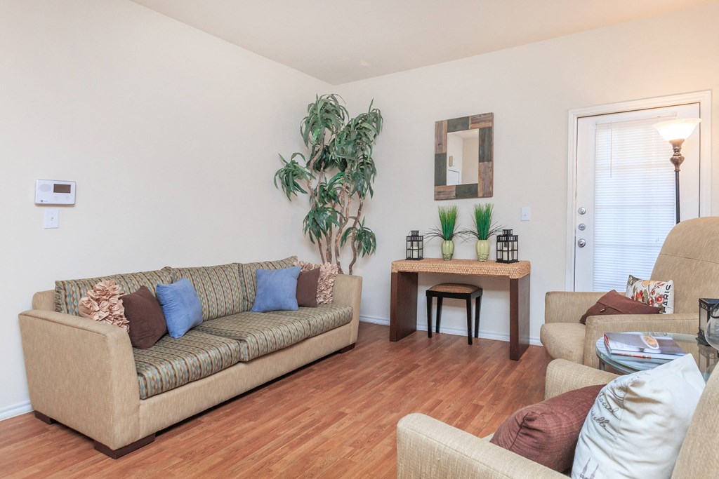 a living room with a couch and a chair and a table
