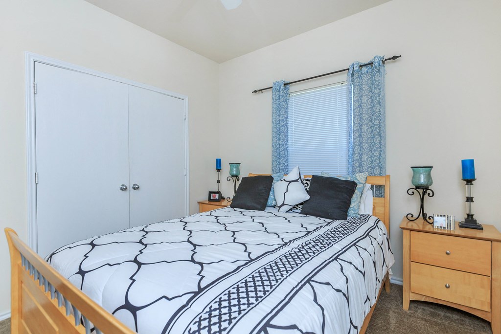 a bedroom with a bed and a dresser and a window