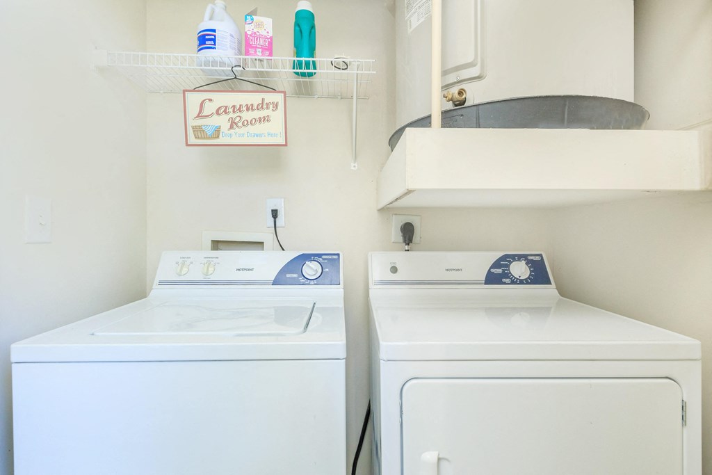 a white laundry room with two washes and a dryer at The Villages at Lost Creek, San Antonio, 78247