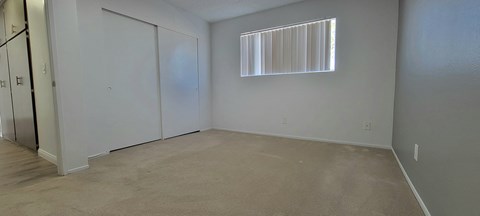 a bedroom with a closet and a window at Villa La Paz Apartments, California, 90706