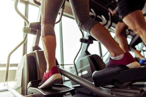 A person is using a treadmill in a gym.
