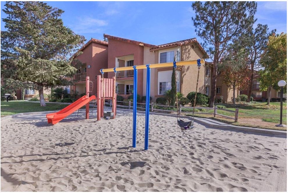 an empty playground in front of a house at Riverview Springs, California