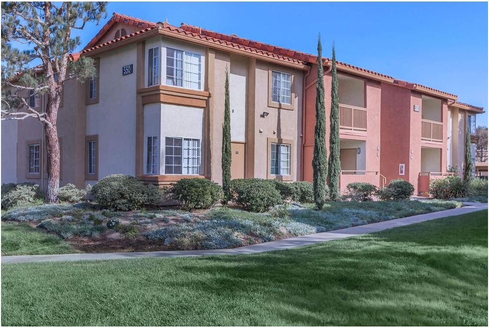 an apartment building with a sidewalk in front of it at Riverview Springs, Oceanside, CA